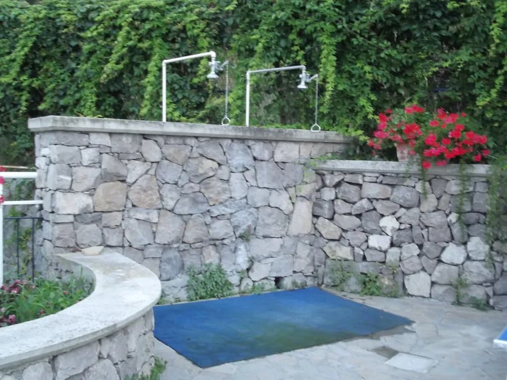 Backyard patio with stone seating wall
