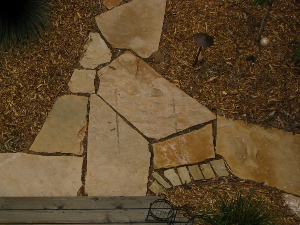 Pavers being laid on a screeded sand bed